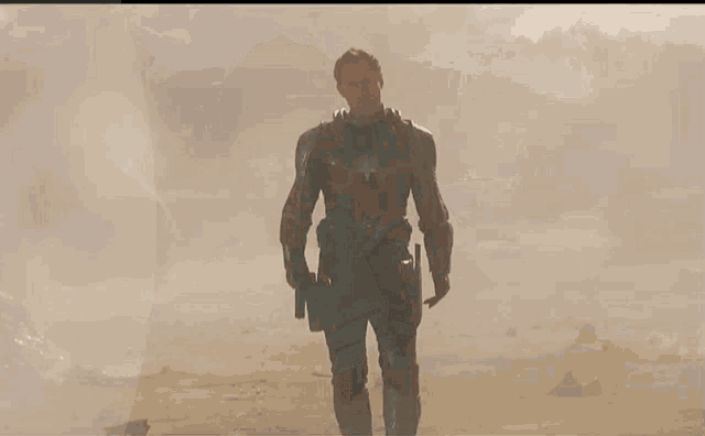 a man in a superhero costume holds a gun