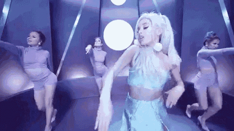ariana grande is dancing in a video with a group of dancers .