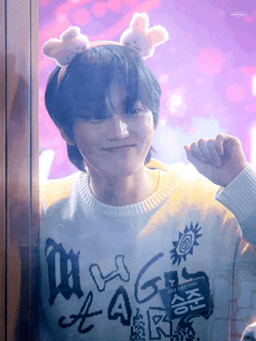 a young man wearing a sweater that says magic