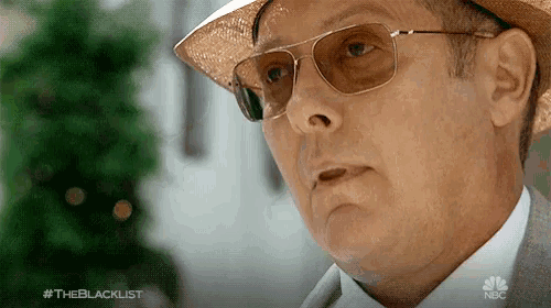 a close up of a man wearing sunglasses and a hat with the hashtag #theblacklist on the bottom