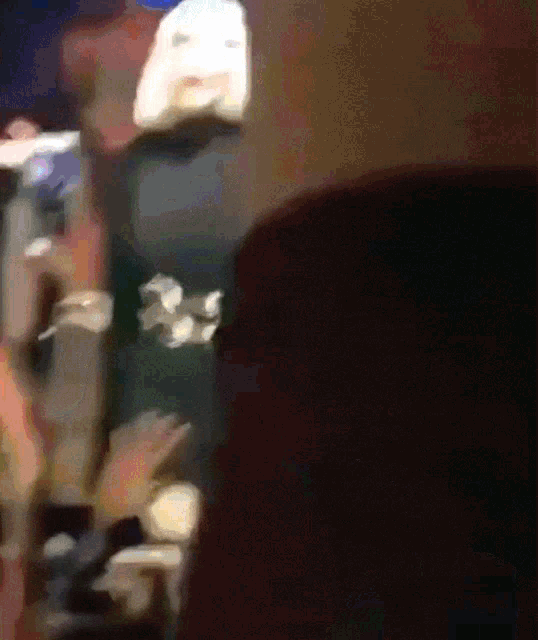 a blurry picture of a person standing in a crowd