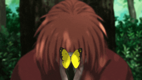 a man with red hair is holding a yellow butterfly in front of his mouth