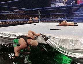 two wrestlers in a wrestling ring with the letter w on their tights