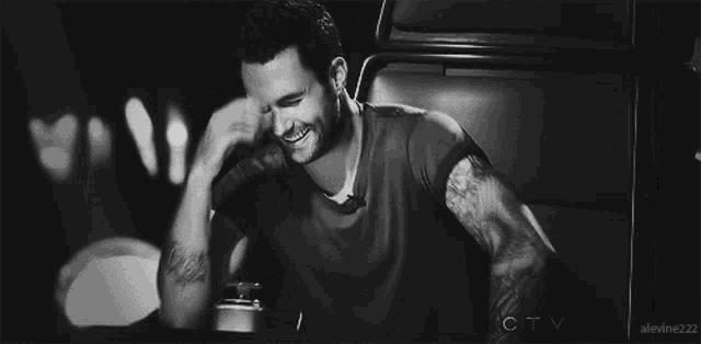a black and white photo of a man laughing with ctv written in the bottom right corner