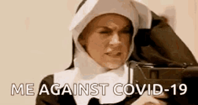 a nun is pointing a gun at the camera and saying `` me against covid-19 '' .