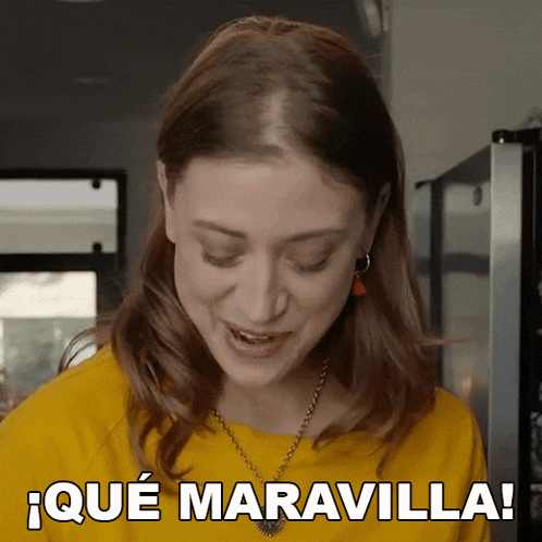 a woman in a yellow shirt says que maravilla in spanish