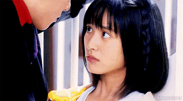 a man and a woman are looking at each other