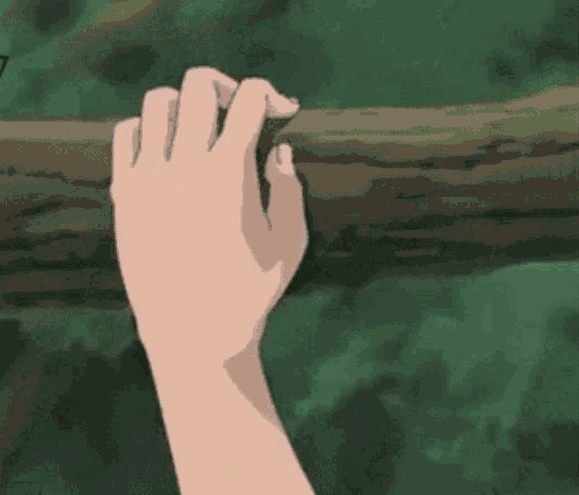 a close up of a person 's hand with long nails reaching out towards something .