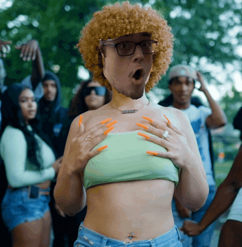 a woman with a surprised look on her face holds her breasts