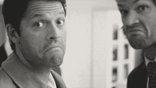 two men in suits and ties are making funny faces .