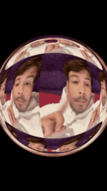a man in a white hoodie is reflected in a sphere