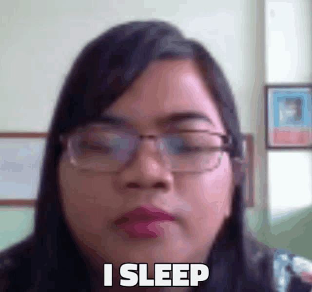a woman wearing glasses is making a funny face and says i sleep .