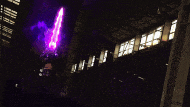 a man in a suit and tie is holding a purple sword with henshin written on it