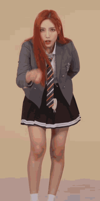 a girl with red hair wearing a suit and tie