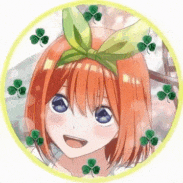 a girl with orange hair and blue eyes is wearing a green bow on her head .