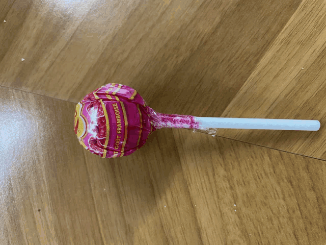 a pink lollipop with the word framboise on the wrapper