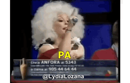 a woman in an afro wig is singing into a microphone and the word pa is on the screen