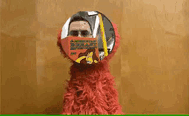 a man in a red costume with the words " i 'm an idiot " above him