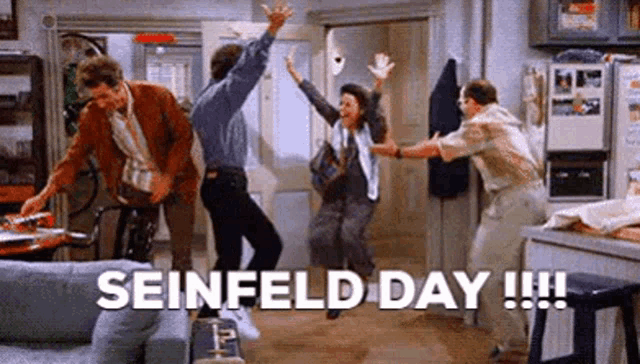 a group of people are jumping in the air in a living room with the words seinfeld day written above them .