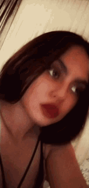 a close up of a woman taking a selfie with red lipstick