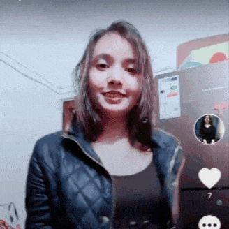 a woman is standing in front of a refrigerator with a picture of a woman on it