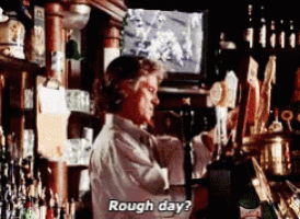 a man in a bar says rough day while looking at a television