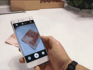 a person is taking a picture of a dollar bill on their phone