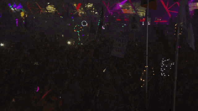 a crowd of people holding up a sign that says this way fucks