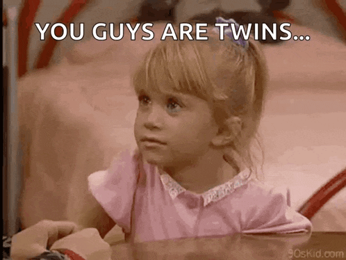 a little girl is sitting at a table with the words " you guys are twins " above her