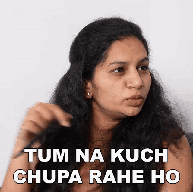 a woman holds her hair and says tum na kuch chupa rahe ho