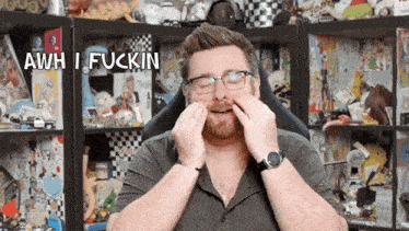 a man with glasses and a watch is making a funny face with the words awh i fuckin above him