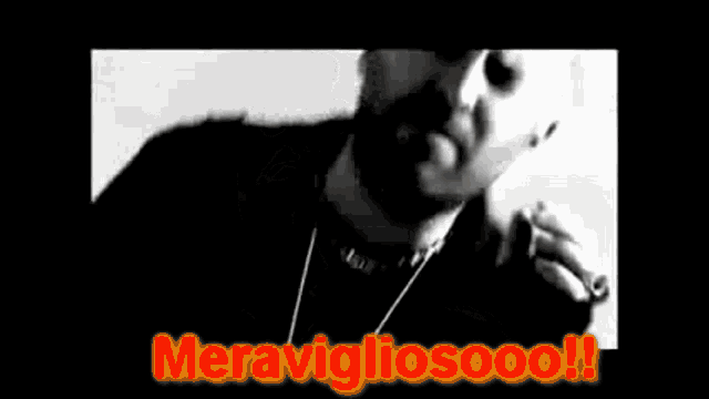 a black and white photo of a man smoking a cigarette with the words meravigliosoooo written on the bottom