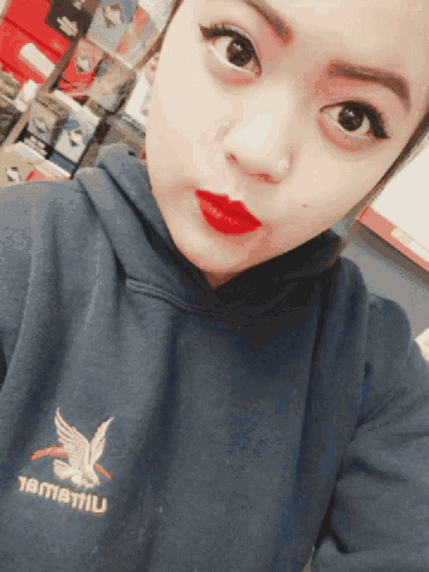 a woman wearing a hoodie that says tamatiu on the front