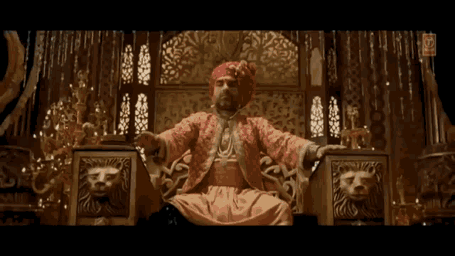 a man in a turban is sitting in a throne