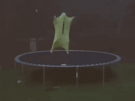 a person is jumping on a trampoline in the dark .