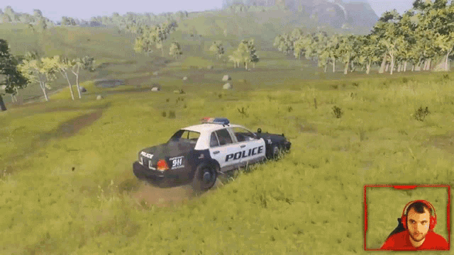 a police car is driving down a dirt road with blood coming out of it