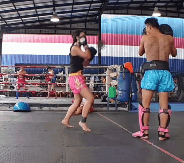 a man and a woman are boxing in a ring and the man has a belt that says diesel