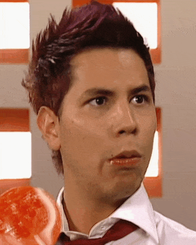 a man with purple hair is wearing a white shirt and a tie