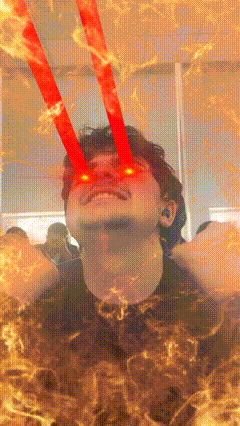 a man with red lights coming out of his eyes is surrounded by flames