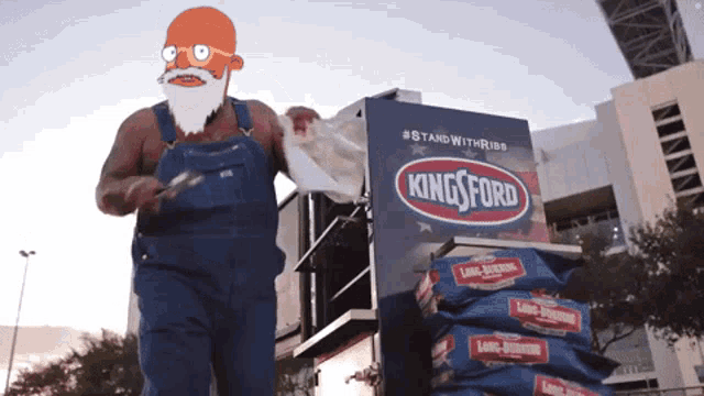 a man in overalls is standing in front of a king ford display