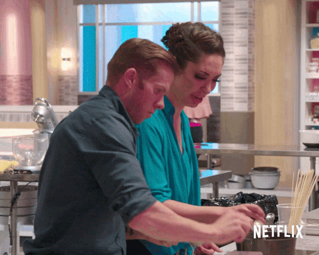 a man and woman in a kitchen with a netflix logo