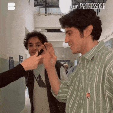 a man in a green and white striped shirt has the word professore written on his shirt