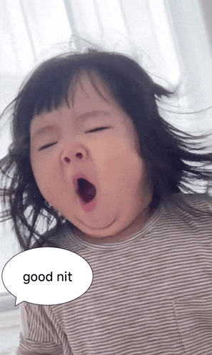 a little girl is yawning with a speech bubble that says good nit