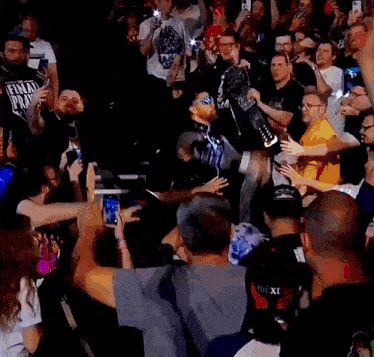 a crowd of people with one man wearing a shirt that says ' fox ' on it