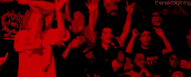 a crowd of people in a dark room with the nextbigthing written in the corner
