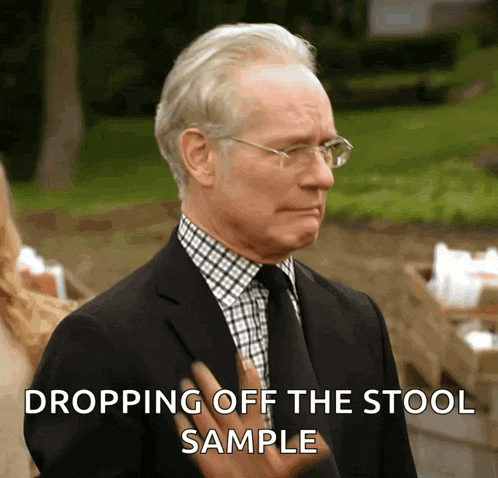 a man in a suit and tie with the words dropping off the stool sample above him